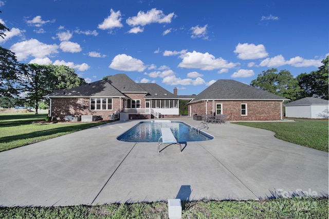 view of pool featuring a yard and a patio