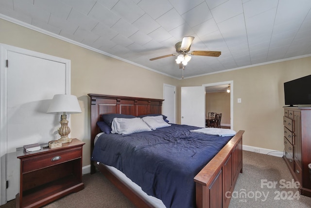 carpeted bedroom featuring ceiling fan and ornamental molding