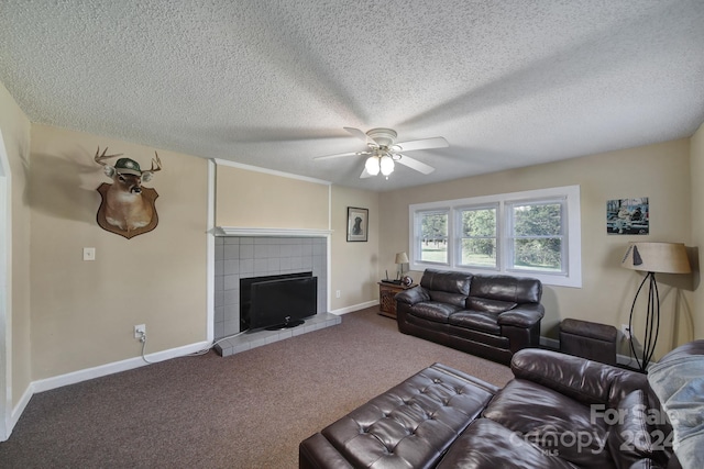 carpeted living room with ceiling fan, a fireplace, and a textured ceiling