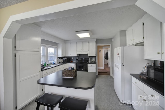 kitchen featuring backsplash, a textured ceiling, white cabinetry, and range