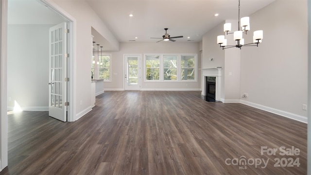 unfurnished living room with dark hardwood / wood-style floors and ceiling fan with notable chandelier