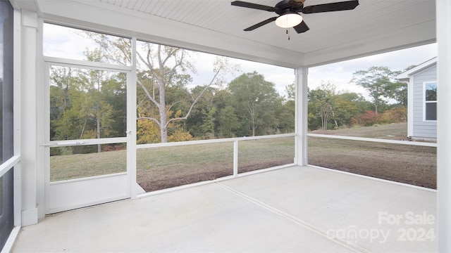 unfurnished sunroom with ceiling fan