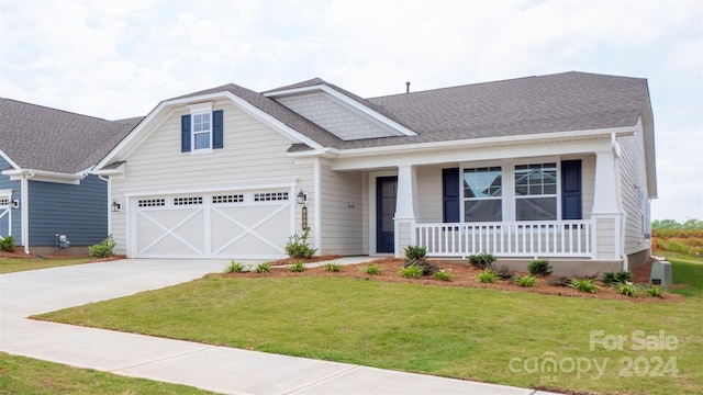 craftsman inspired home featuring a porch, a garage, and a front yard