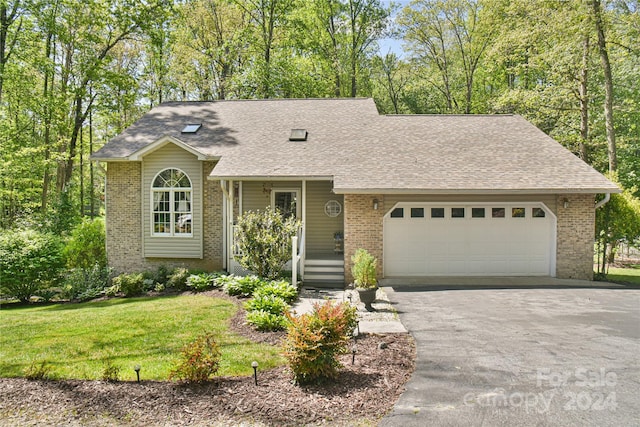 ranch-style home featuring a front lawn and a garage