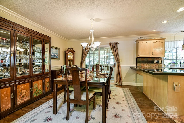 dining space featuring ornamental molding, an inviting chandelier, plenty of natural light, and dark wood-type flooring