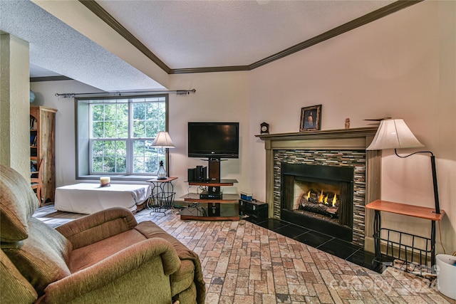 living room featuring crown molding, a tile fireplace, and a textured ceiling