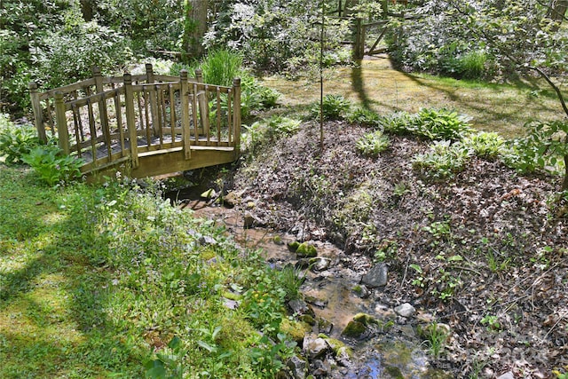 view of yard featuring a deck with water view