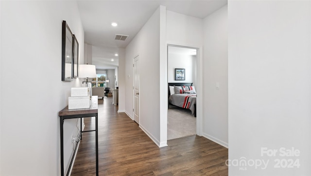 corridor featuring dark hardwood / wood-style flooring