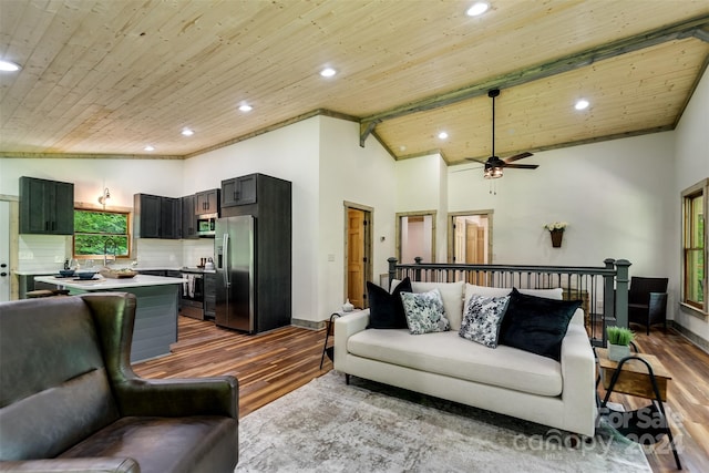 living room with lofted ceiling with beams, hardwood / wood-style floors, ceiling fan, and wood ceiling