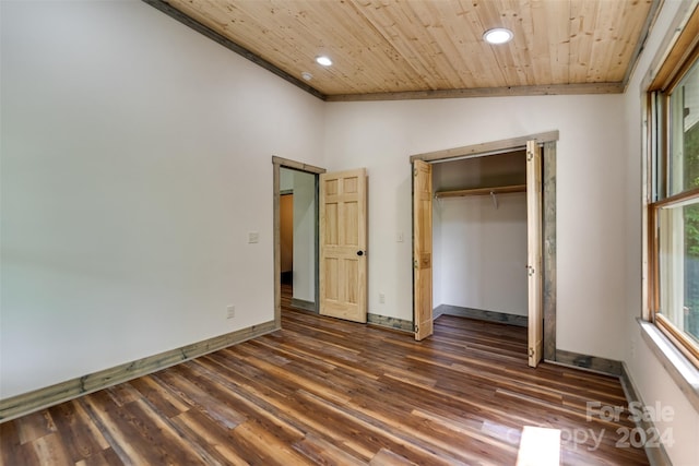 unfurnished bedroom featuring a closet, vaulted ceiling, wood ceiling, and dark wood-type flooring