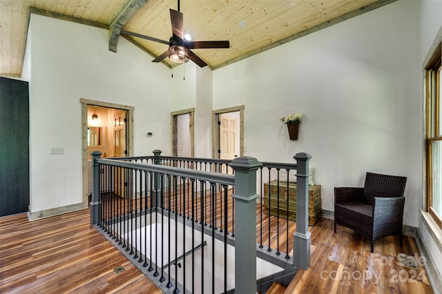 hall featuring high vaulted ceiling, beam ceiling, wood-type flooring, and wooden ceiling