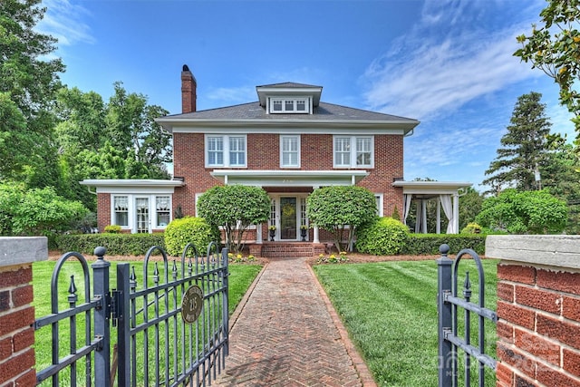 colonial house featuring a front yard