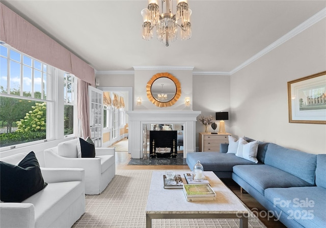 living room featuring an inviting chandelier, wood finished floors, a high end fireplace, and crown molding