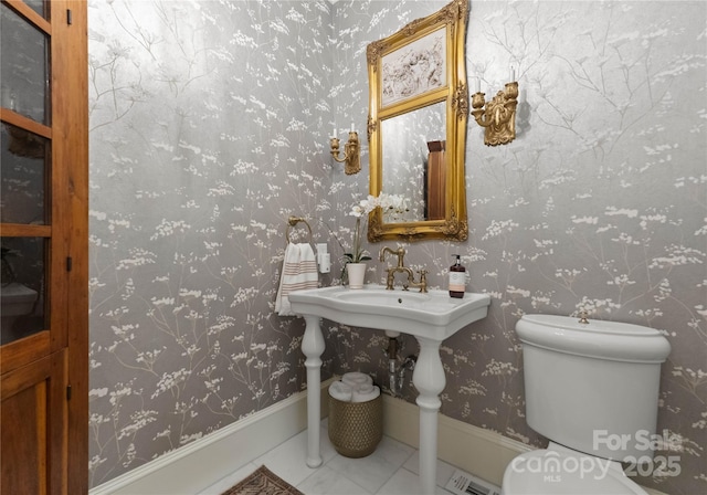 bathroom featuring tile patterned flooring and toilet