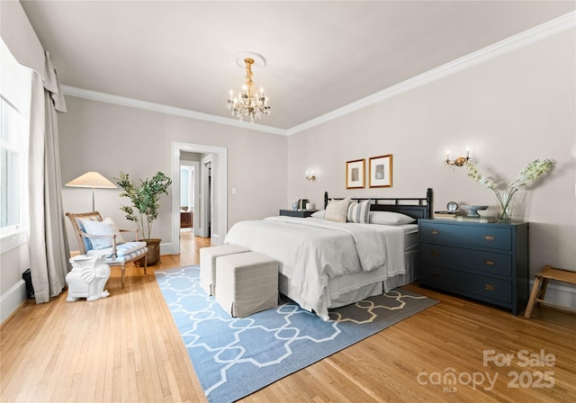 bedroom featuring light hardwood / wood-style floors, crown molding, and a notable chandelier