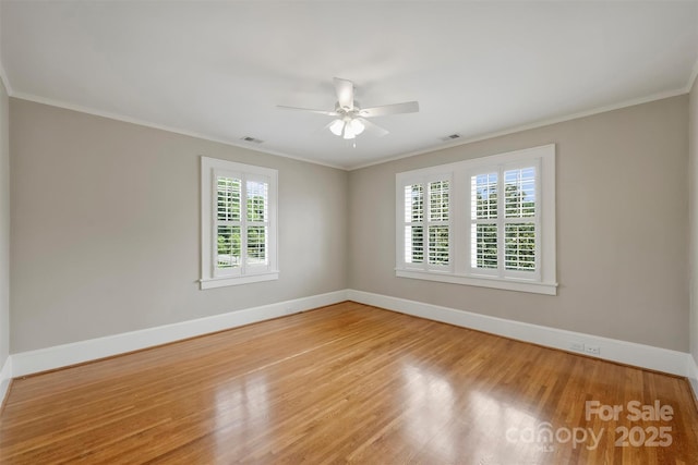 spare room featuring ceiling fan, crown molding, and light hardwood / wood-style flooring