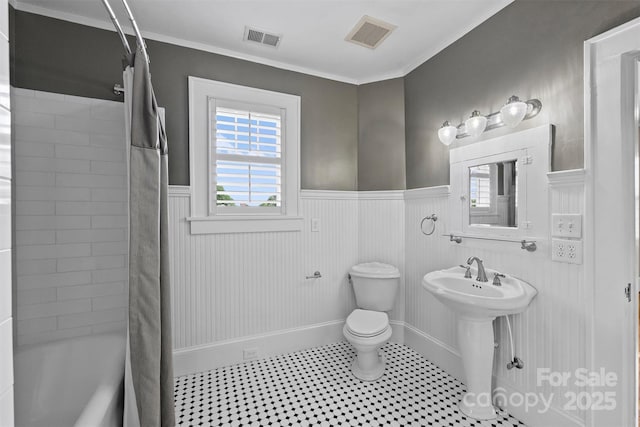 full bathroom with crown molding, sink, shower / tub combo, and toilet