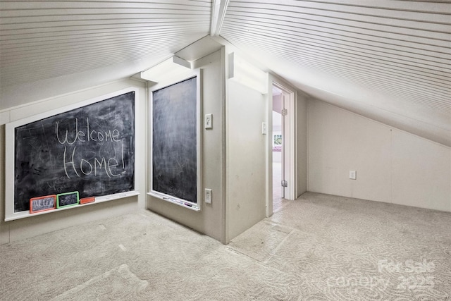 bonus room featuring light carpet and vaulted ceiling