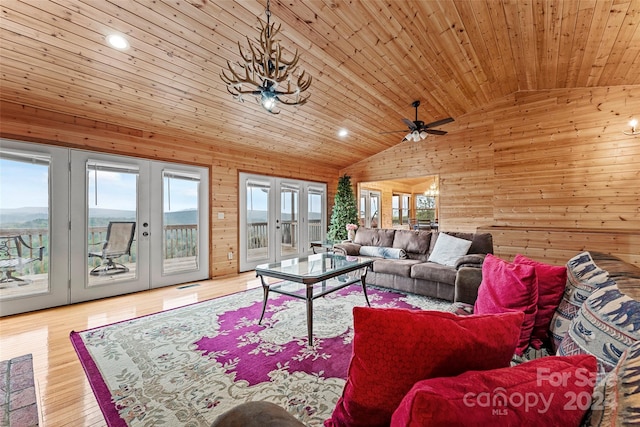 living room featuring french doors, light hardwood / wood-style flooring, ceiling fan, lofted ceiling, and wood ceiling