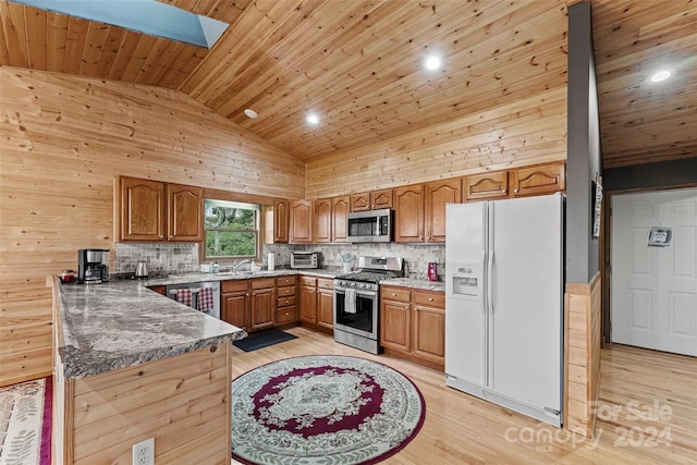 kitchen featuring appliances with stainless steel finishes, wood ceiling, a skylight, tasteful backsplash, and light hardwood / wood-style floors