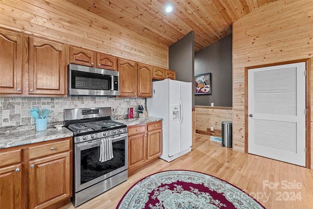 kitchen with light hardwood / wood-style flooring, backsplash, stainless steel appliances, light stone counters, and wood ceiling