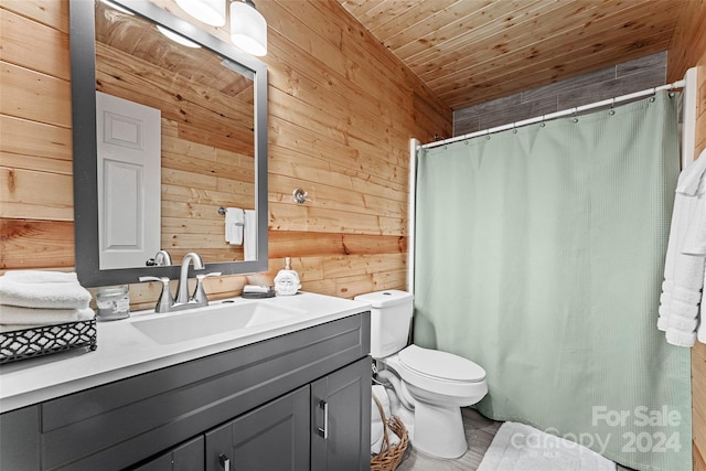 bathroom featuring wooden ceiling, toilet, vanity with extensive cabinet space, and wooden walls