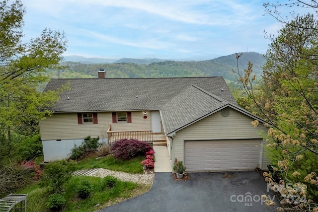 ranch-style house featuring a mountain view and a garage