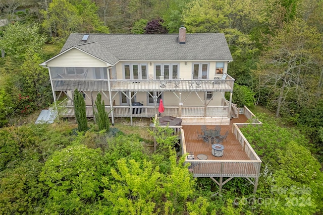 back of house featuring a wooden deck