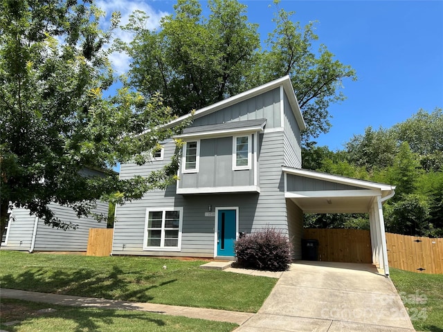 view of front of house with a carport and a front lawn