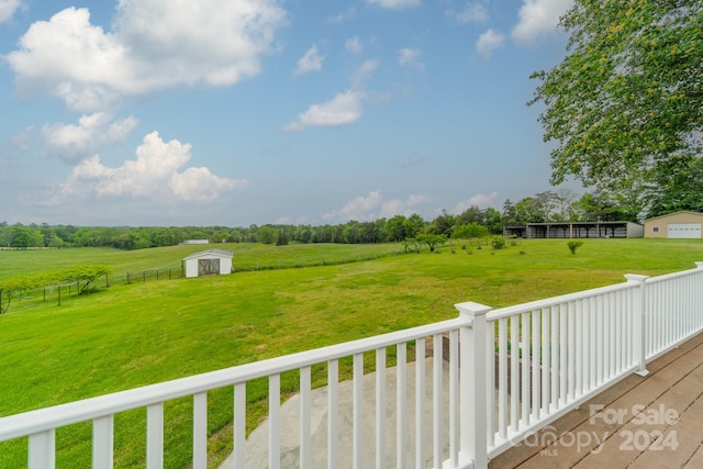 view of yard with a rural view and a storage unit