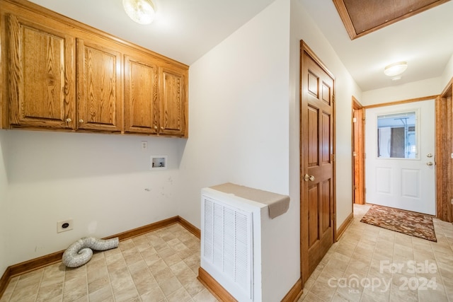 washroom with hookup for a washing machine, electric dryer hookup, cabinets, and light tile floors