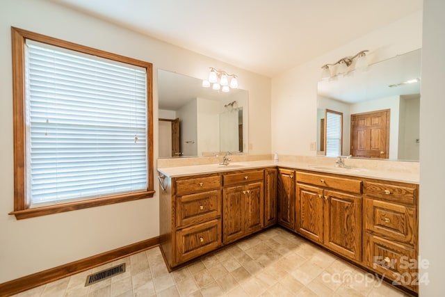 bathroom featuring double sink, oversized vanity, and tile flooring