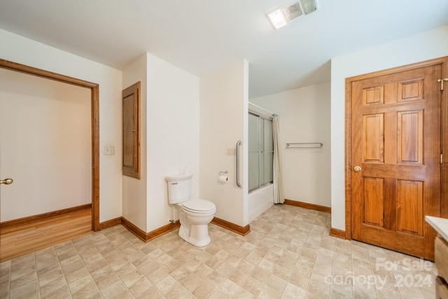 bathroom featuring tile flooring and toilet