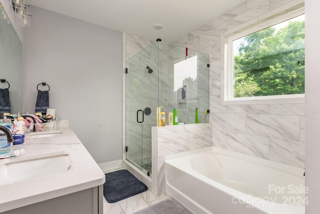 bathroom featuring separate shower and tub and vanity