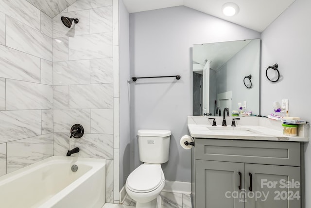 full bathroom featuring lofted ceiling, tiled shower / bath, vanity, and toilet