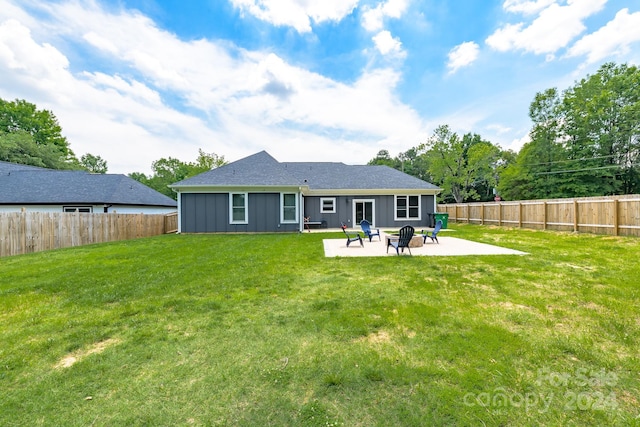 back of house featuring a lawn and a patio