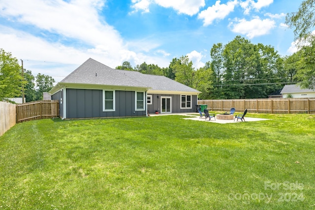 rear view of house featuring a yard, a patio, and a fire pit