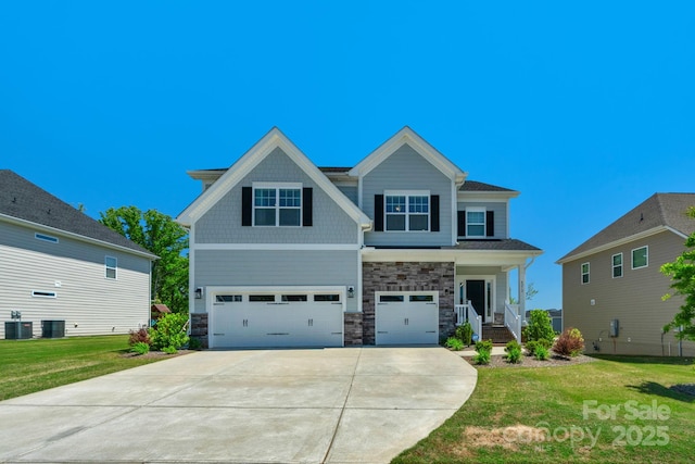 craftsman-style home with a front yard, central AC, and a garage