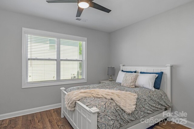 bedroom with ceiling fan and dark hardwood / wood-style flooring