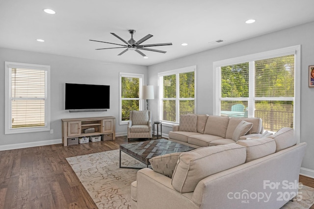 living room featuring wood-type flooring and ceiling fan