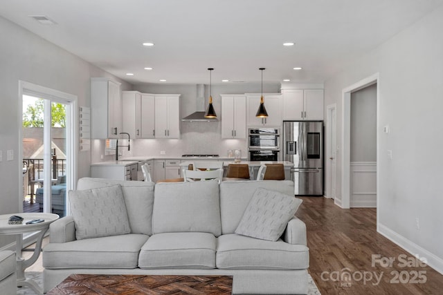 living room with dark wood-type flooring and sink