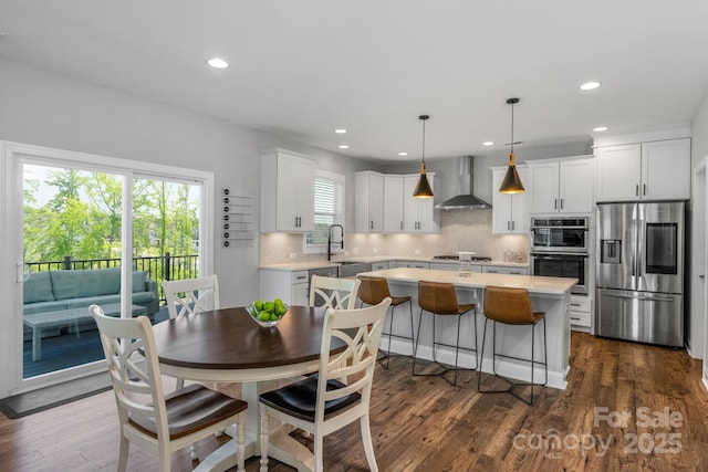 dining space featuring sink and dark hardwood / wood-style flooring