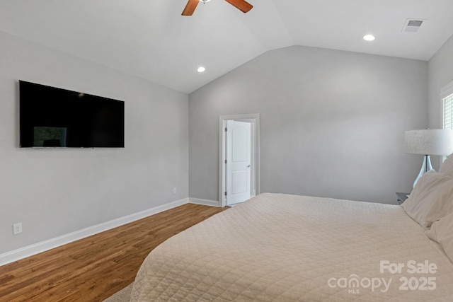 bedroom featuring ceiling fan, hardwood / wood-style floors, and vaulted ceiling