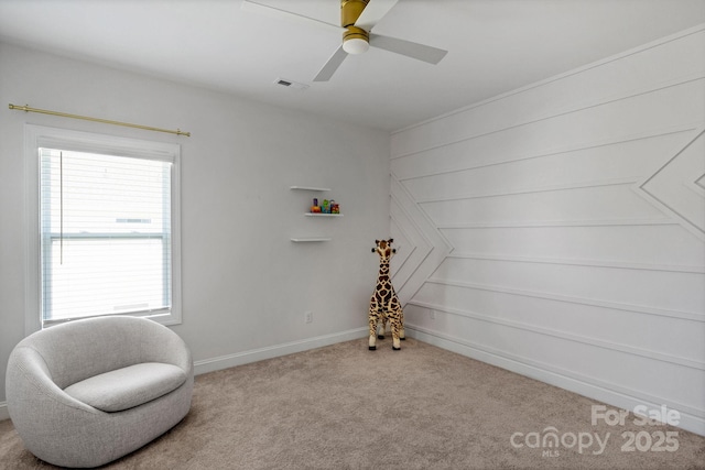 living area with ceiling fan and light carpet