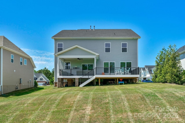 back of house with a yard, a deck, and ceiling fan