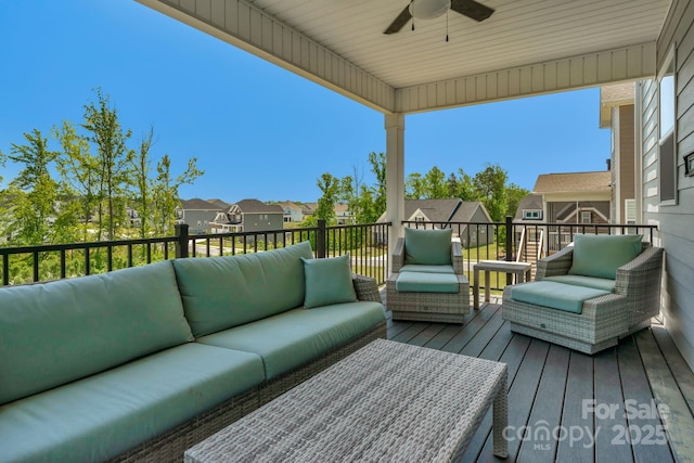 wooden deck with outdoor lounge area and ceiling fan