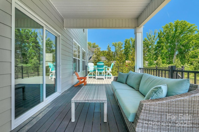 wooden deck with an outdoor living space