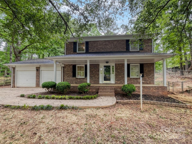 front facade featuring covered porch and a garage