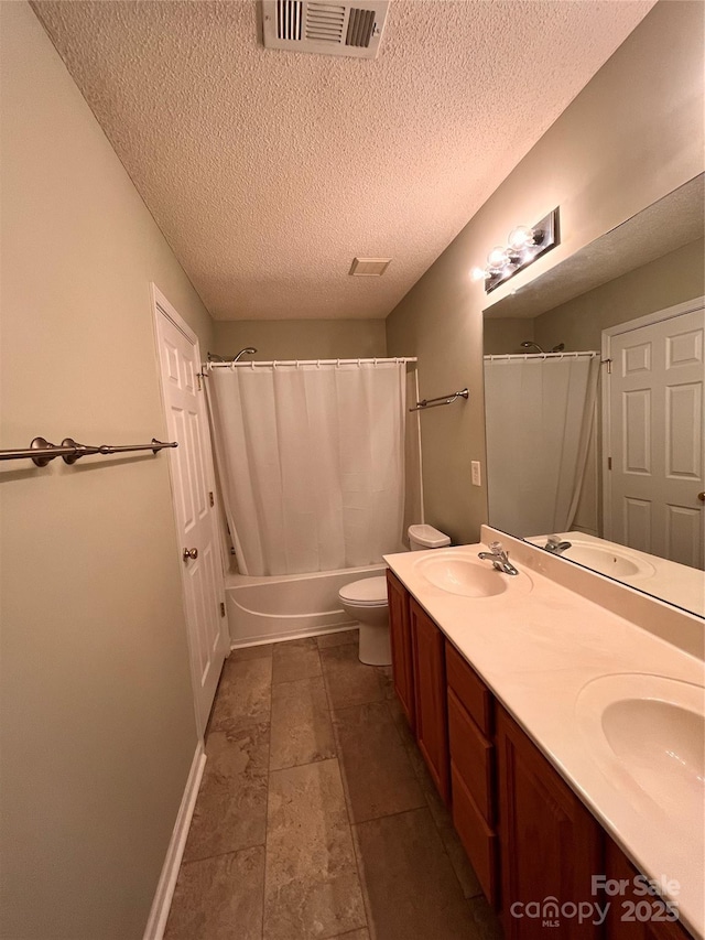 full bathroom featuring a textured ceiling, double vanity, shower / bathtub combination with curtain, toilet, and baseboards