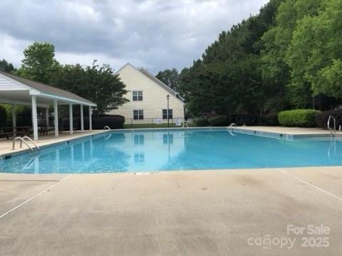 community pool with a patio area
